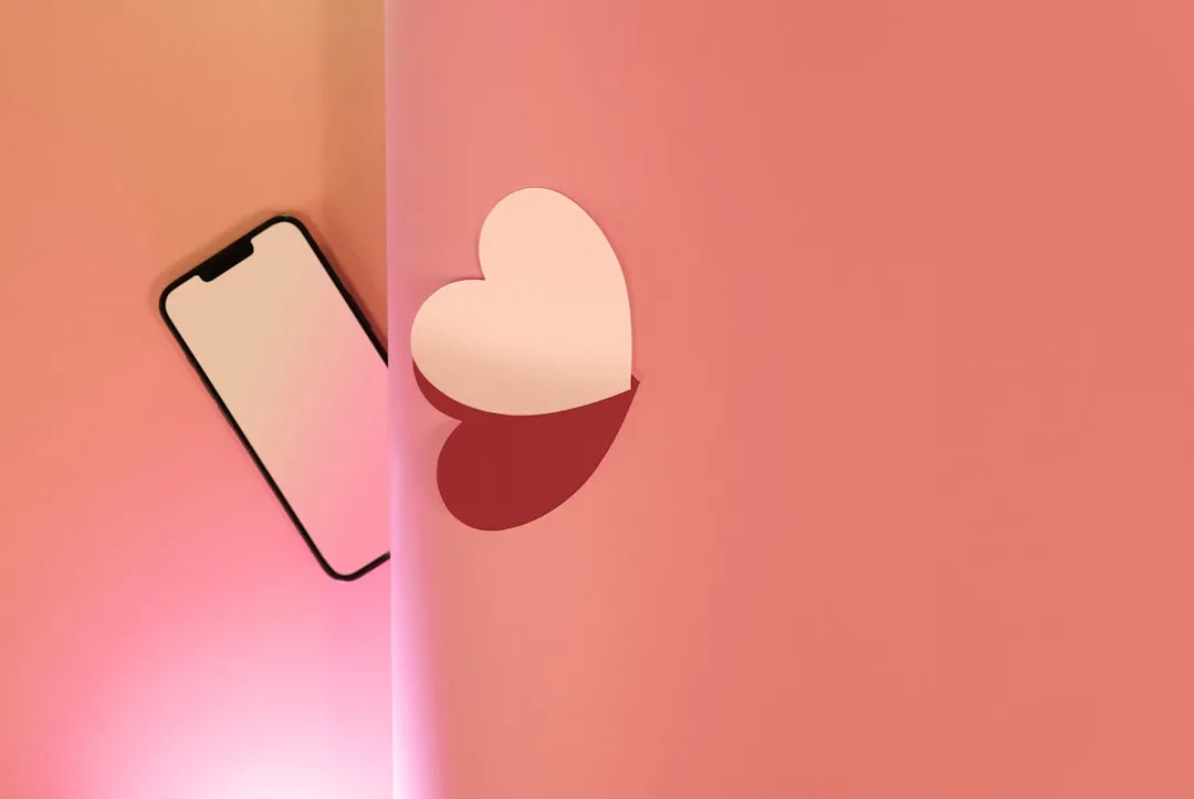a cell phone with a heart cut out of it